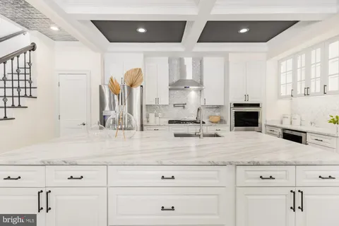 a kitchen with stainless steel appliances kitchen island granite countertop a stove and a sink
