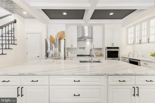 a kitchen with stainless steel appliances kitchen island granite countertop a stove and a sink