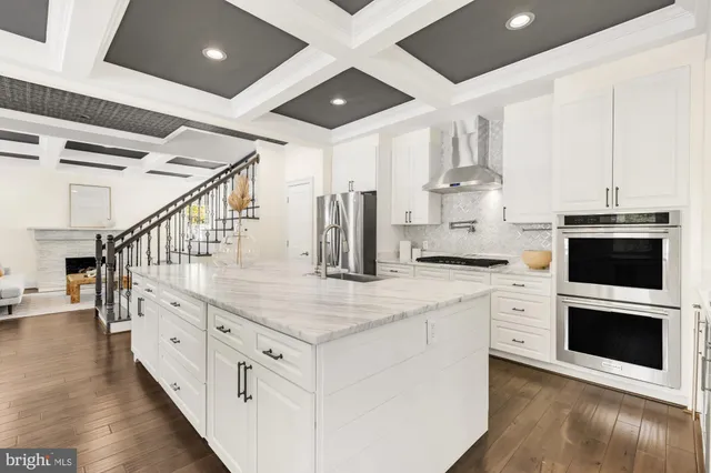 a kitchen with granite countertop a sink and a stove top oven