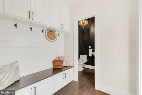 a bathroom with a sink vanity mirror and toilet