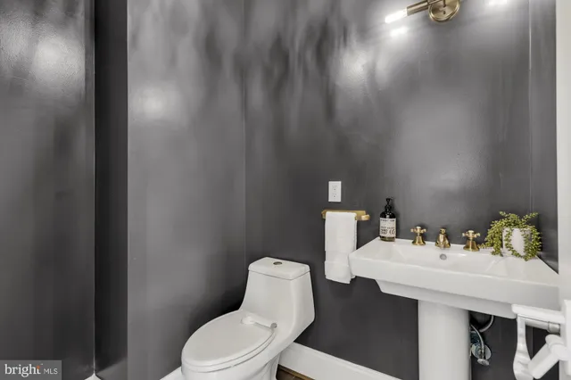 a view of hallway with furniture and wooden floor