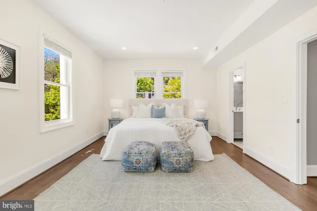 a spacious bedroom with a bed and a couch