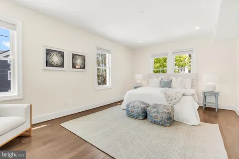 a spacious bedroom with a bed and a lamp