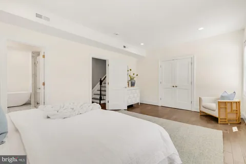 a bathroom with a double vanity sink a mirror and a bathtub