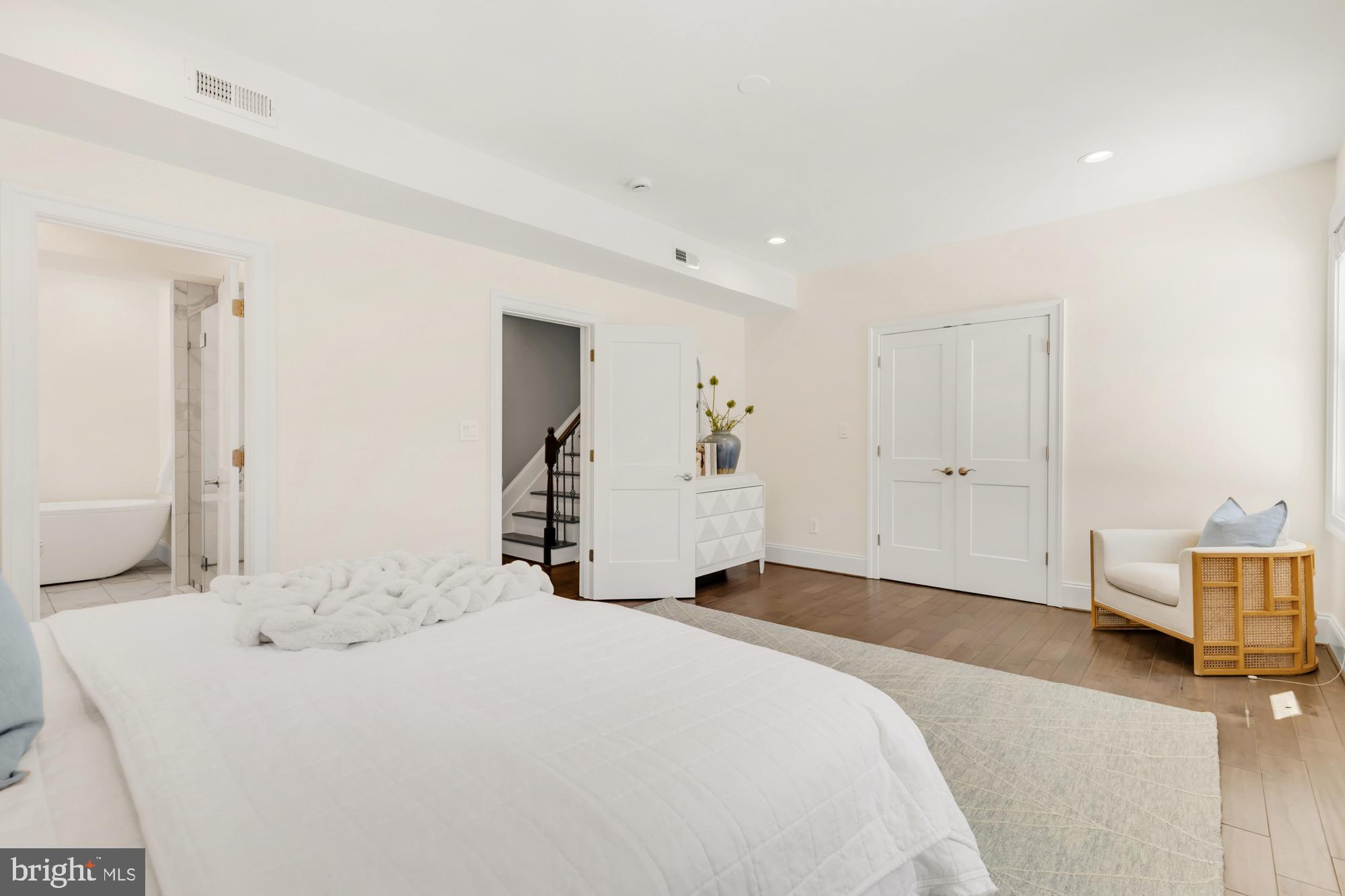 1202 Decatur Street Northwest Washington, DC 20011 - Photo 32 of 53 a spacious bedroom with a bed and a lamp