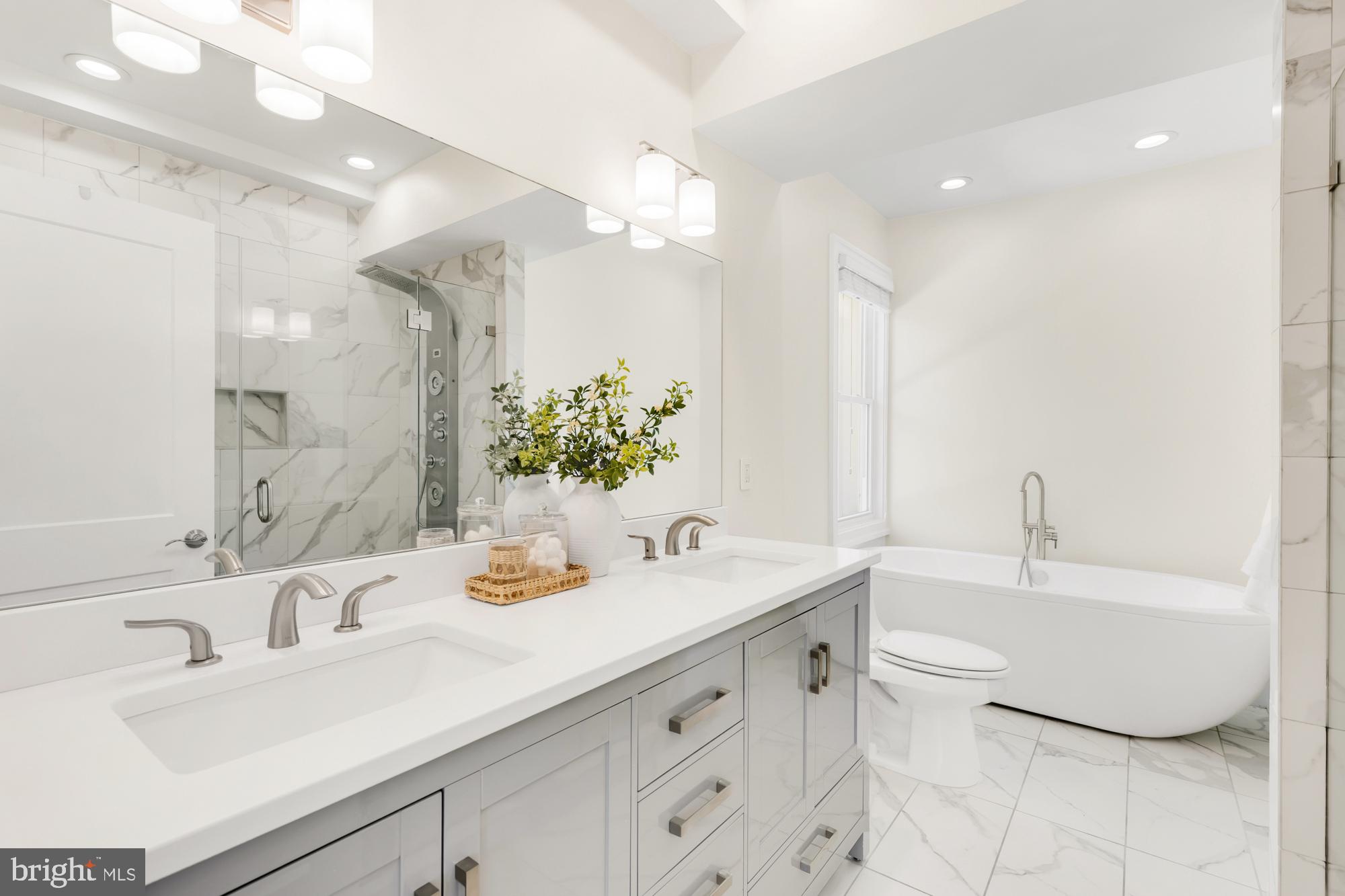 1202 Decatur Street Northwest Washington, DC 20011 - Photo 33 of 53 a bathroom with a double vanity sink a mirror and a bathtub