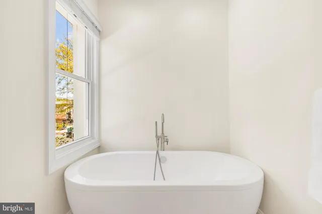 a view of walk in closet with clothes