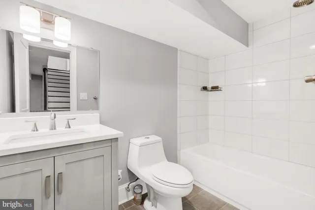 a kitchen with white cabinets and refrigerator