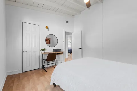 a bed room with a bed and a chair