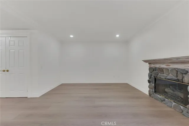 a view of an empty room with a fireplace
