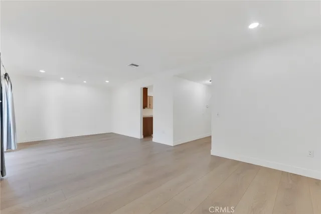 a view of an empty room with a kitchen
