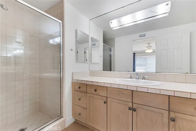 a bathroom with a granite countertop sink mirror and double