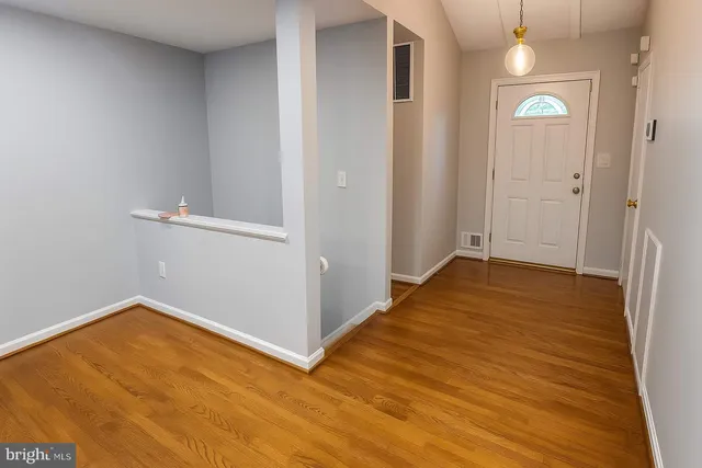 a view of a room with wooden floor