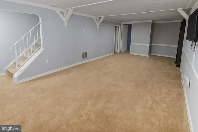 a view of an empty room with stairs
