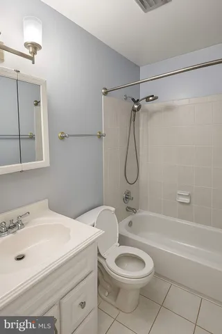 a bathroom with a granite countertop sink a toilet and shower