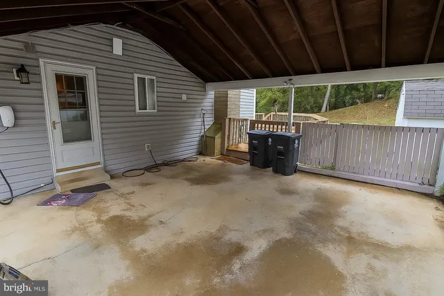 a view of a backyard with furniture and trees