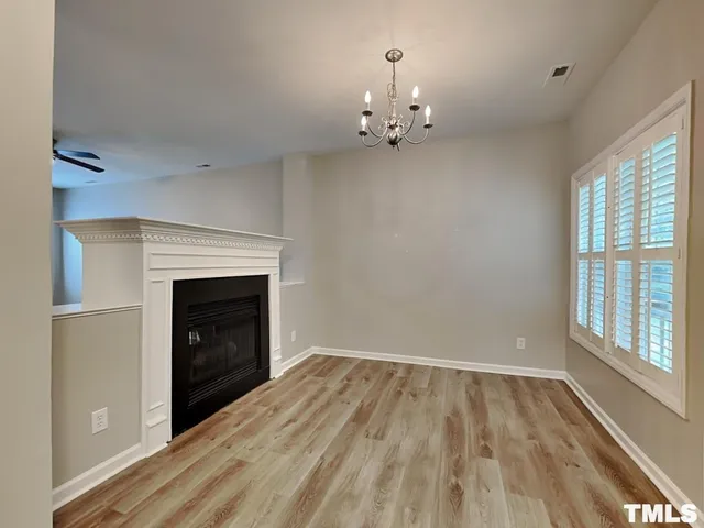 wooden floor in an empty room with a fireplace