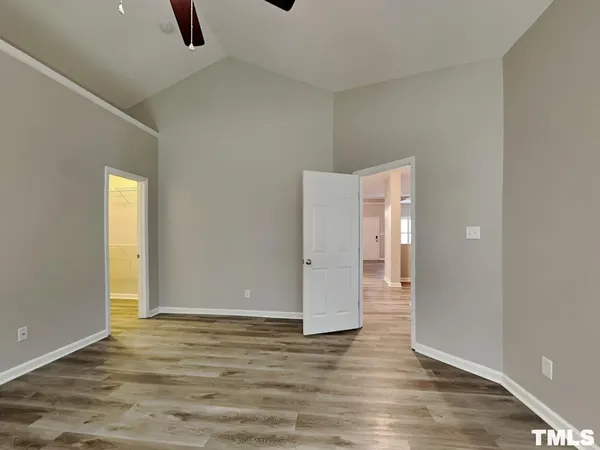 a view of an empty room with wooden floor