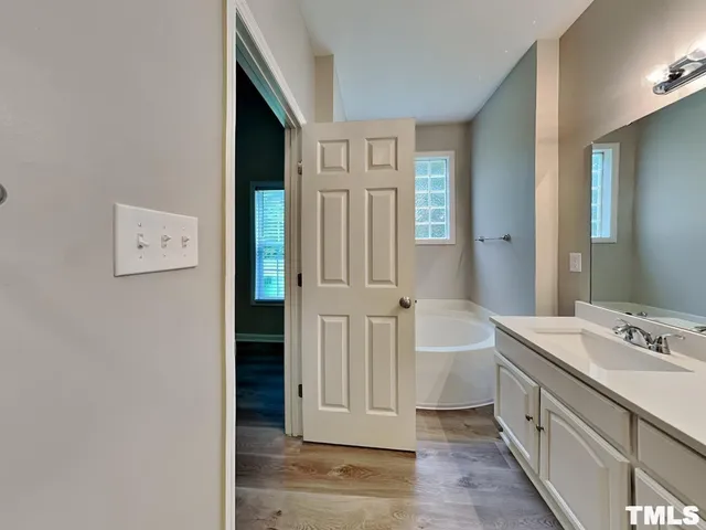 a bathroom with a double vanity sink and a mirror