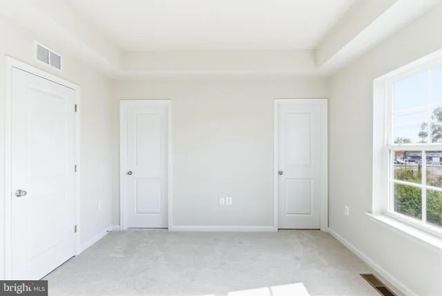 an empty room with windows and entrance