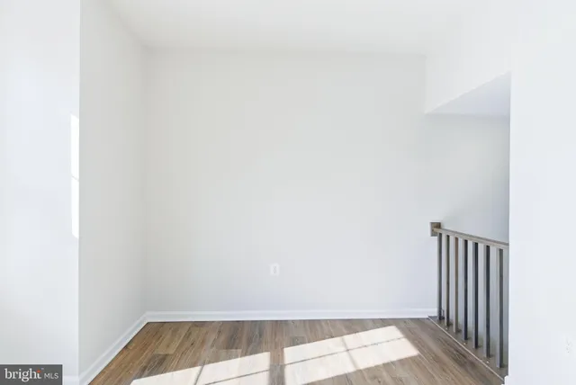 a view of a room with wooden floor and a window