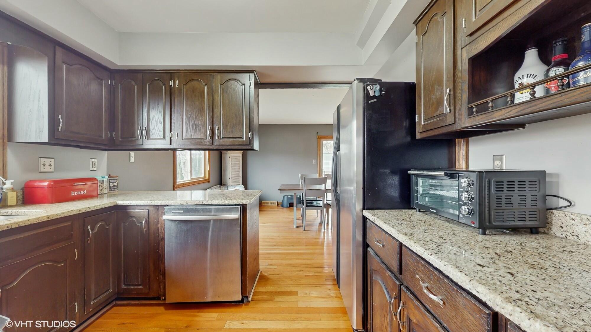 1980 Greenvalley Drive Crown Point, IN 46307 - Photo 12 of 45 a kitchen with stainless steel appliances granite countertop a stove a sink and a microwave