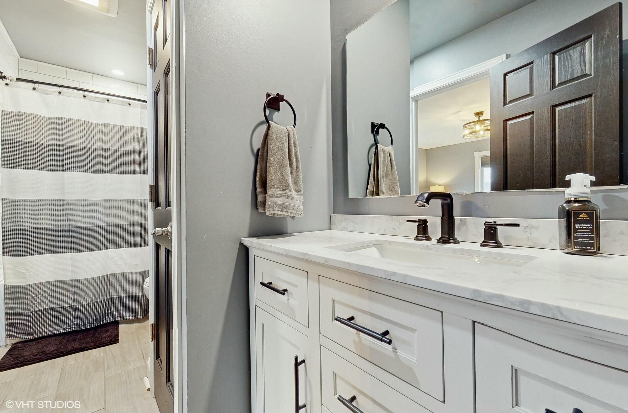 1980 Greenvalley Drive Crown Point, IN 46307 - Photo 22 of 45 a bathroom with a sink and a mirror