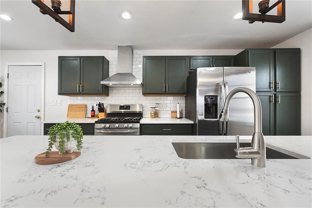 1315 Bower Hill Road Pittsburgh, PA 15243 - Photo 19 of 43 a kitchen with stainless steel appliances kitchen island granite countertop a sink and a stove top oven