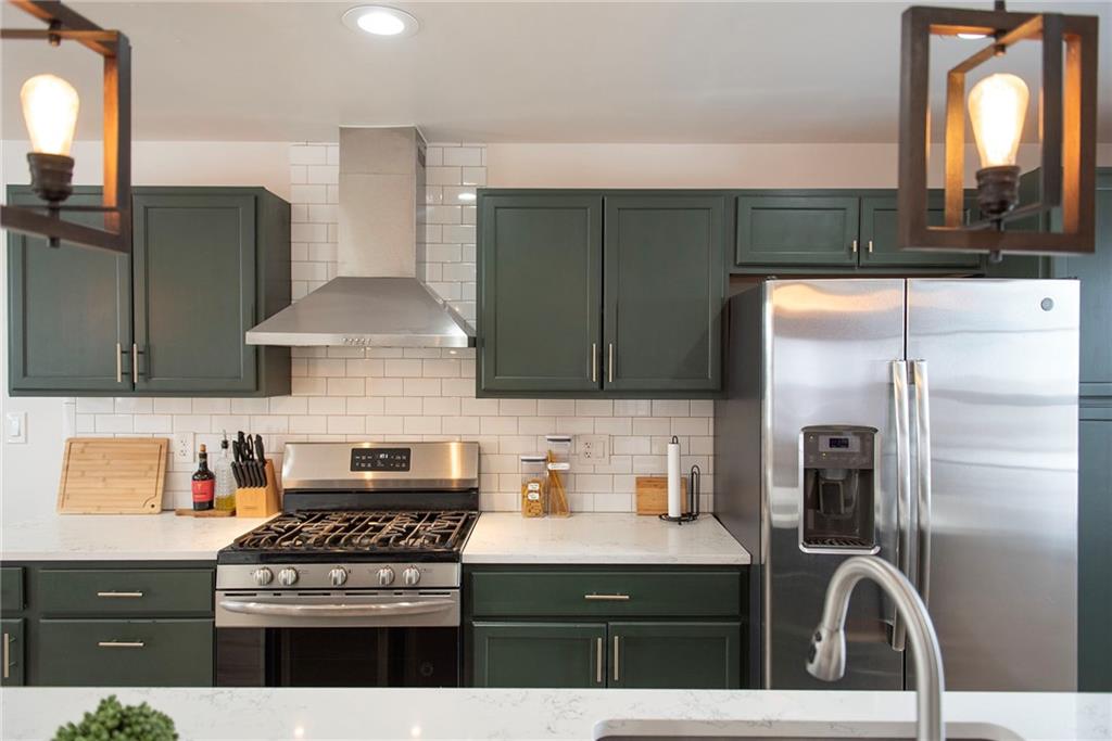 1315 Bower Hill Road Pittsburgh, PA 15243 - Photo 23 of 43 a kitchen with stainless steel appliances granite countertop a stove a refrigerator and a microwave