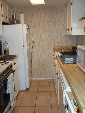 a kitchen with a stove top oven and cabinets