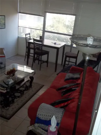 a living room with furniture a rug and a table