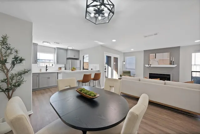 a living room with furniture and a dining table