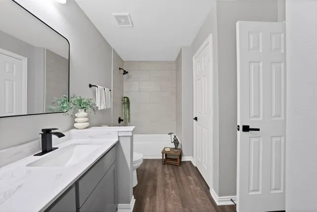 a bathroom with a sink a large mirror and a shower