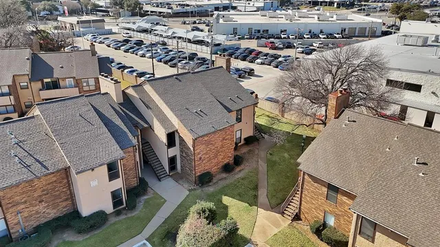 an aerial view of a house with a yard