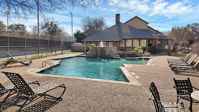 a view of a house with backyard sitting area and swimming pool