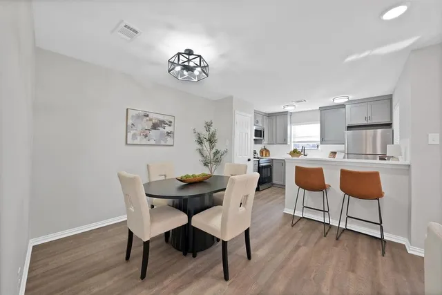a view of a dining room with furniture and wooden floor