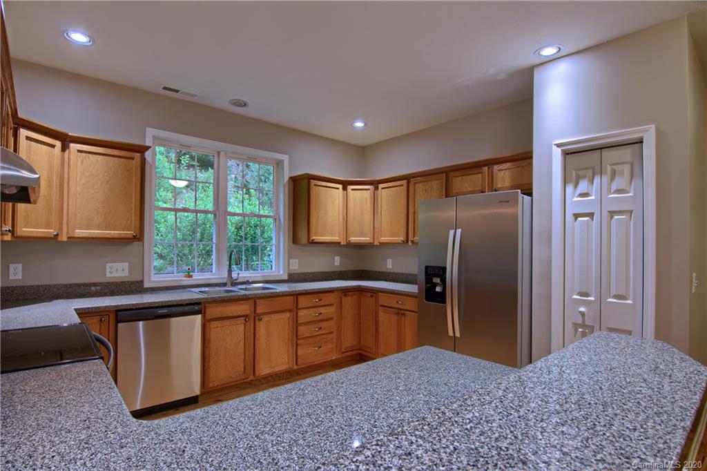 2322 Locust Grove Road Hendersonville, NC 28792 - Photo 12 of 40 a kitchen with stainless steel appliances granite countertop a refrigerator and a sink