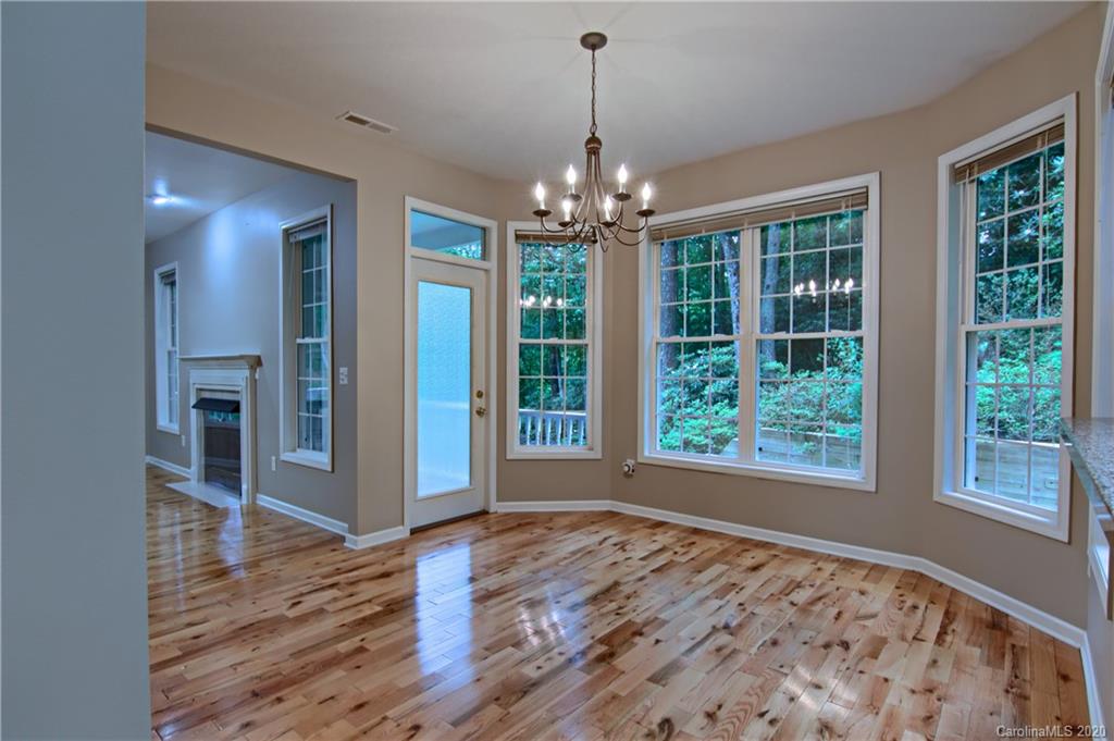 2322 Locust Grove Road Hendersonville, NC 28792 - Photo 13 of 40 a view of an empty room with wooden floor and a window