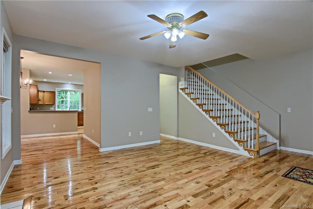 2322 Locust Grove Road Hendersonville, NC 28792 - Photo 15 of 40 wooden floor in an empty room with a chandelier fan