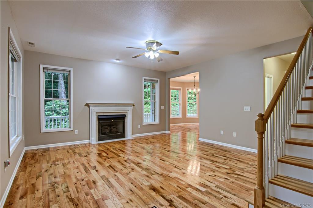 2322 Locust Grove Road Hendersonville, NC 28792 - Photo 16 of 40 a view of an empty room with window and chandelier fan