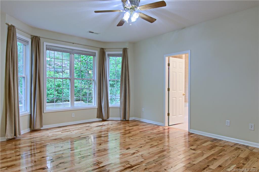 2322 Locust Grove Road Hendersonville, NC 28792 - Photo 18 of 40 a view of an empty room with window and wooden floor