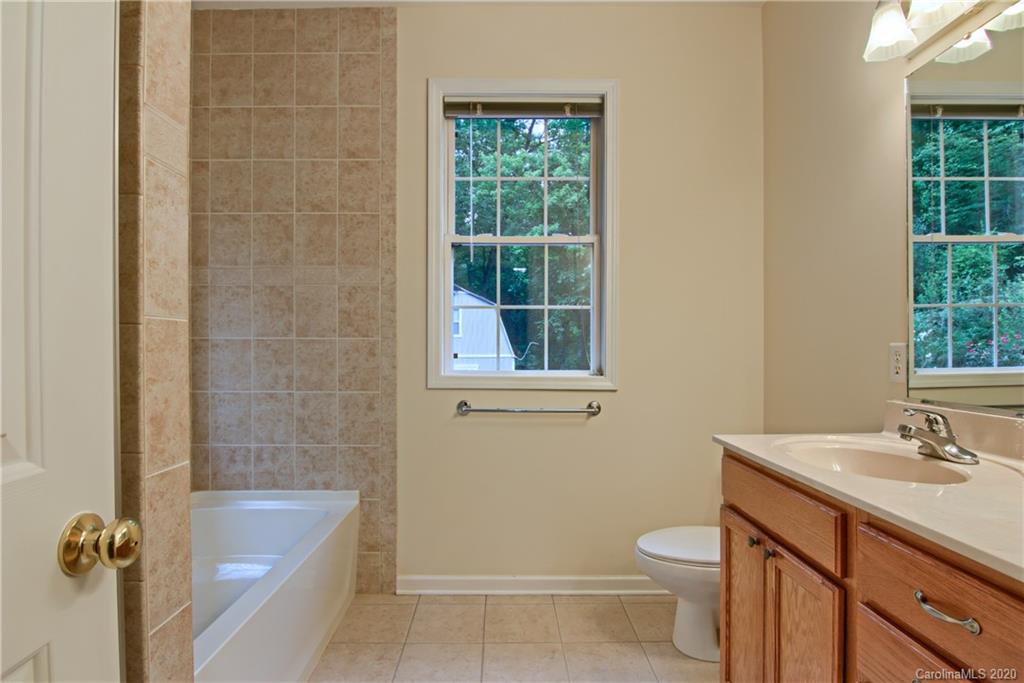 2322 Locust Grove Road Hendersonville, NC 28792 - Photo 20 of 40 a bathroom with a sink a toilet and shower