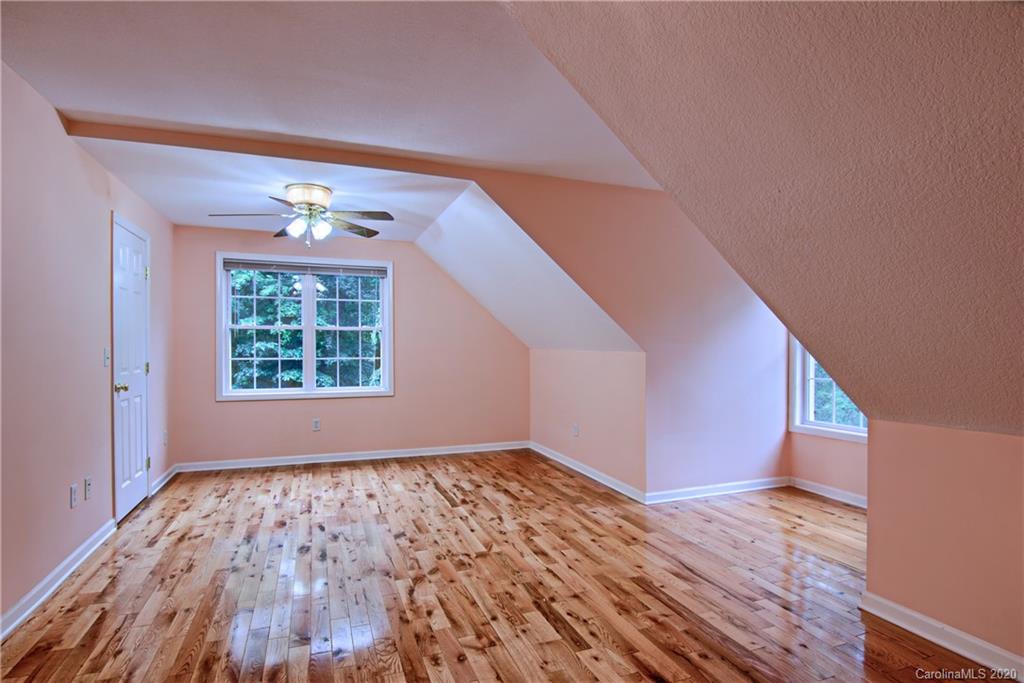2322 Locust Grove Road Hendersonville, NC 28792 - Photo 21 of 40 a view of an empty room with wooden floor and a window