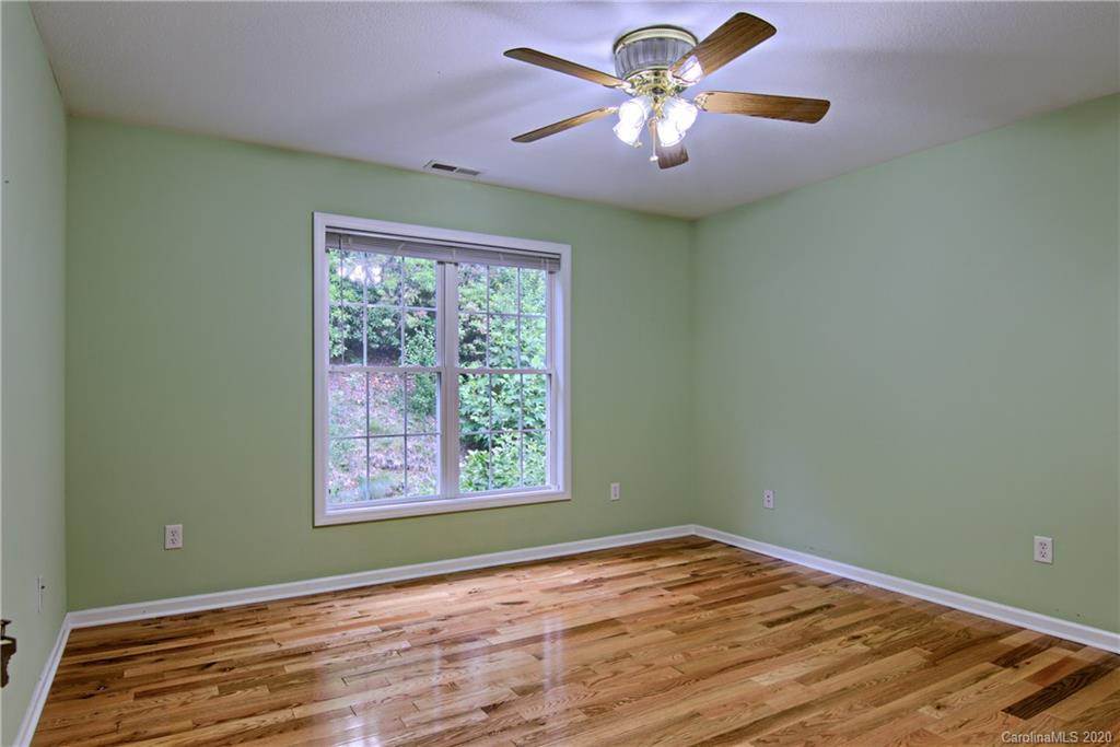 2322 Locust Grove Road Hendersonville, NC 28792 - Photo 22 of 40 a view of an empty room with window and wooden floor