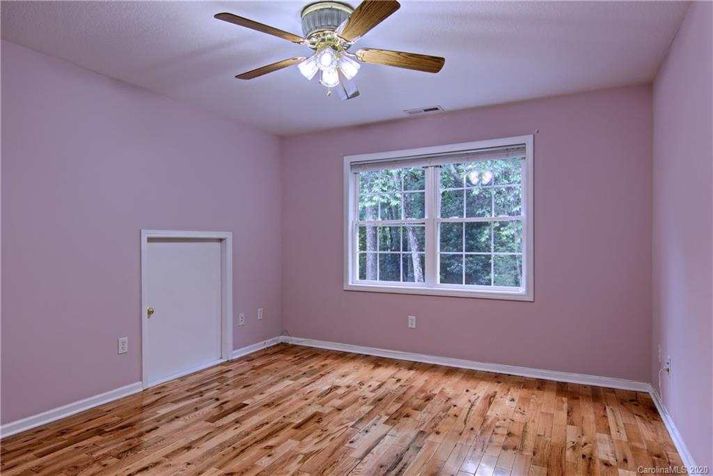 2322 Locust Grove Road Hendersonville, NC 28792 - Photo 23 of 40 a view of an empty room with a window and wooden floor