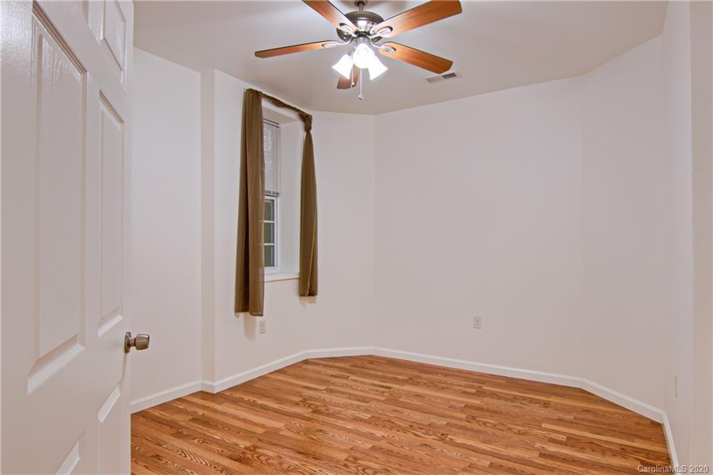 2322 Locust Grove Road Hendersonville, NC 28792 - Photo 25 of 40 a bedroom with a bed and a chandelier