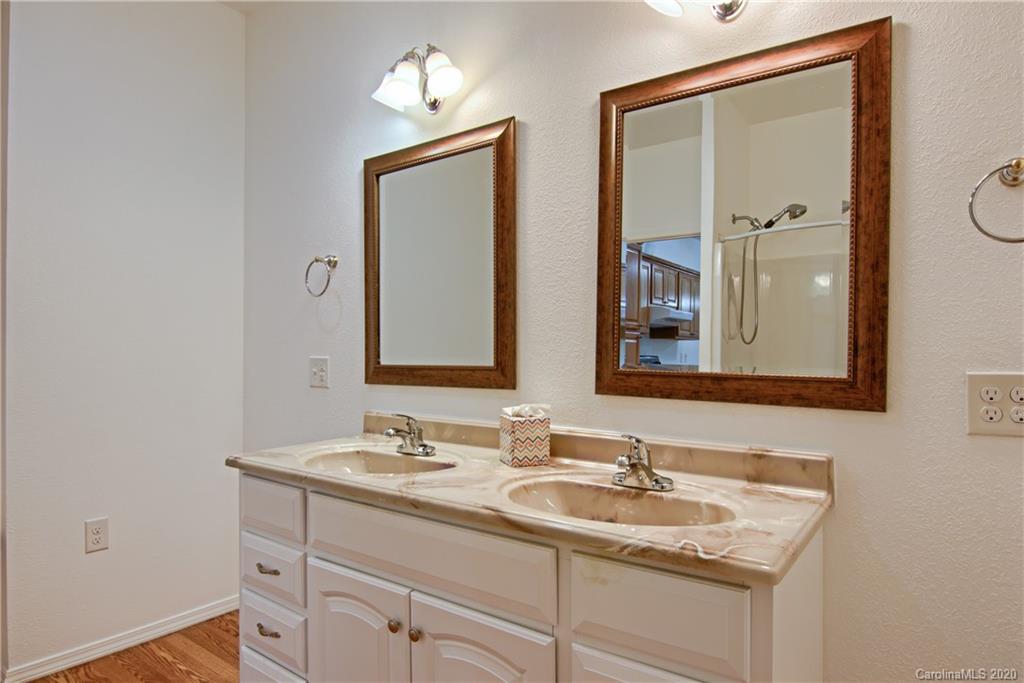 2322 Locust Grove Road Hendersonville, NC 28792 - Photo 26 of 40 a bathroom with a granite countertop sink a mirror and a