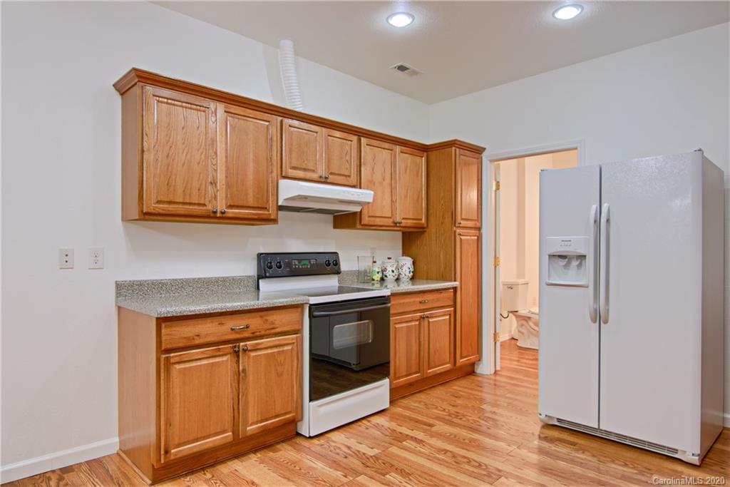2322 Locust Grove Road Hendersonville, NC 28792 - Photo 30 of 40 a kitchen with stainless steel appliances granite countertop a refrigerator and a stove top oven