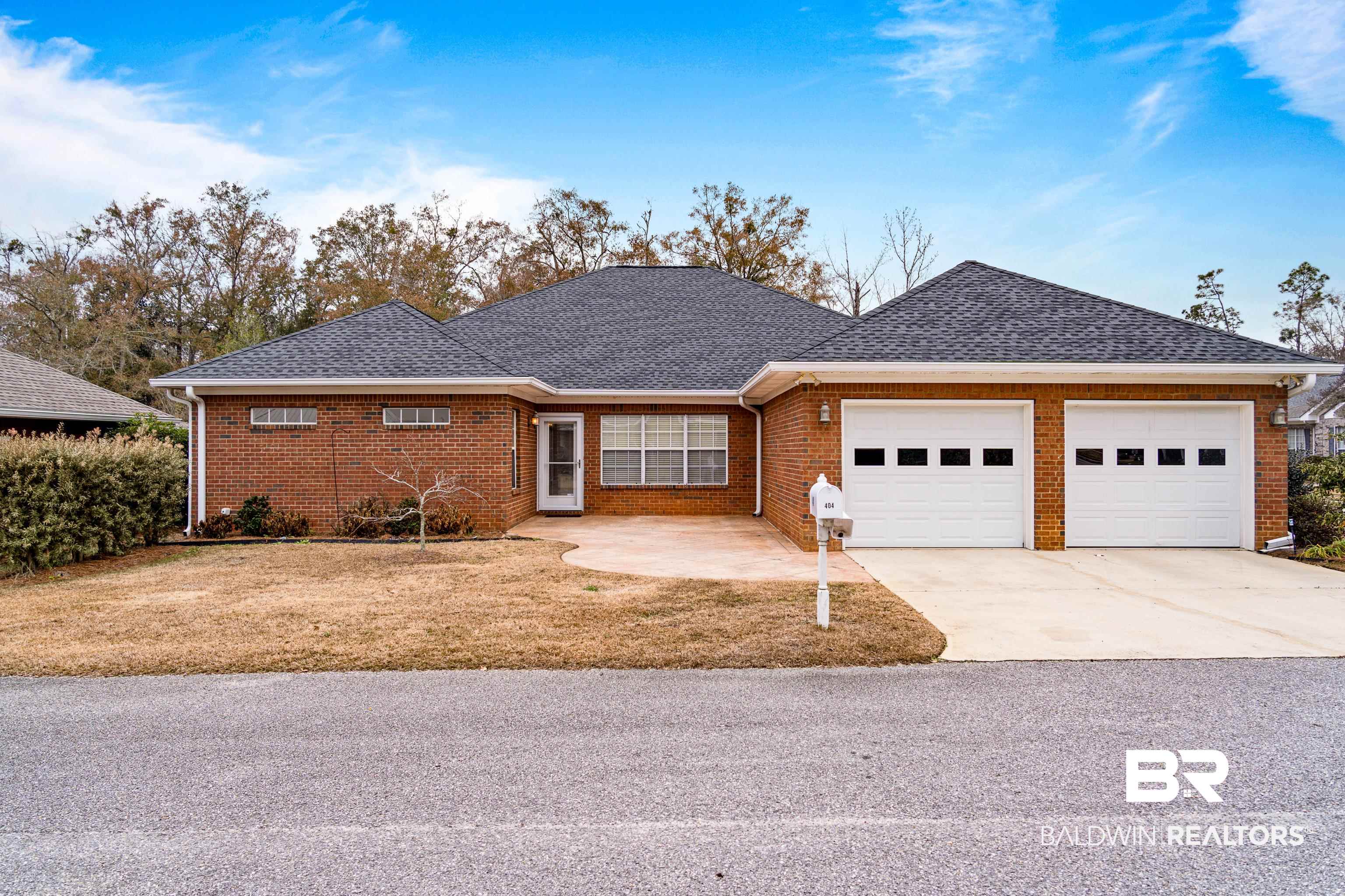 404 Savannah Lane Foley, AL 36535 - Photo 28 of 29 Single story home with a garage, brick siding, concrete driveway, roof with shingles, and a front lawn