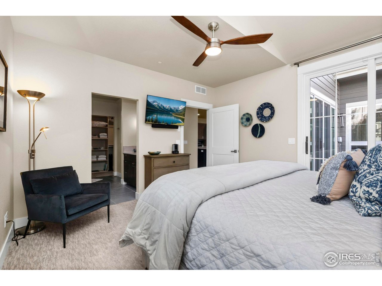 910 Hill Pond Road, Unit 15 Fort Collins, CO 80526 - Photo 12 of 43 a bedroom with a bed a couch and a chandelier